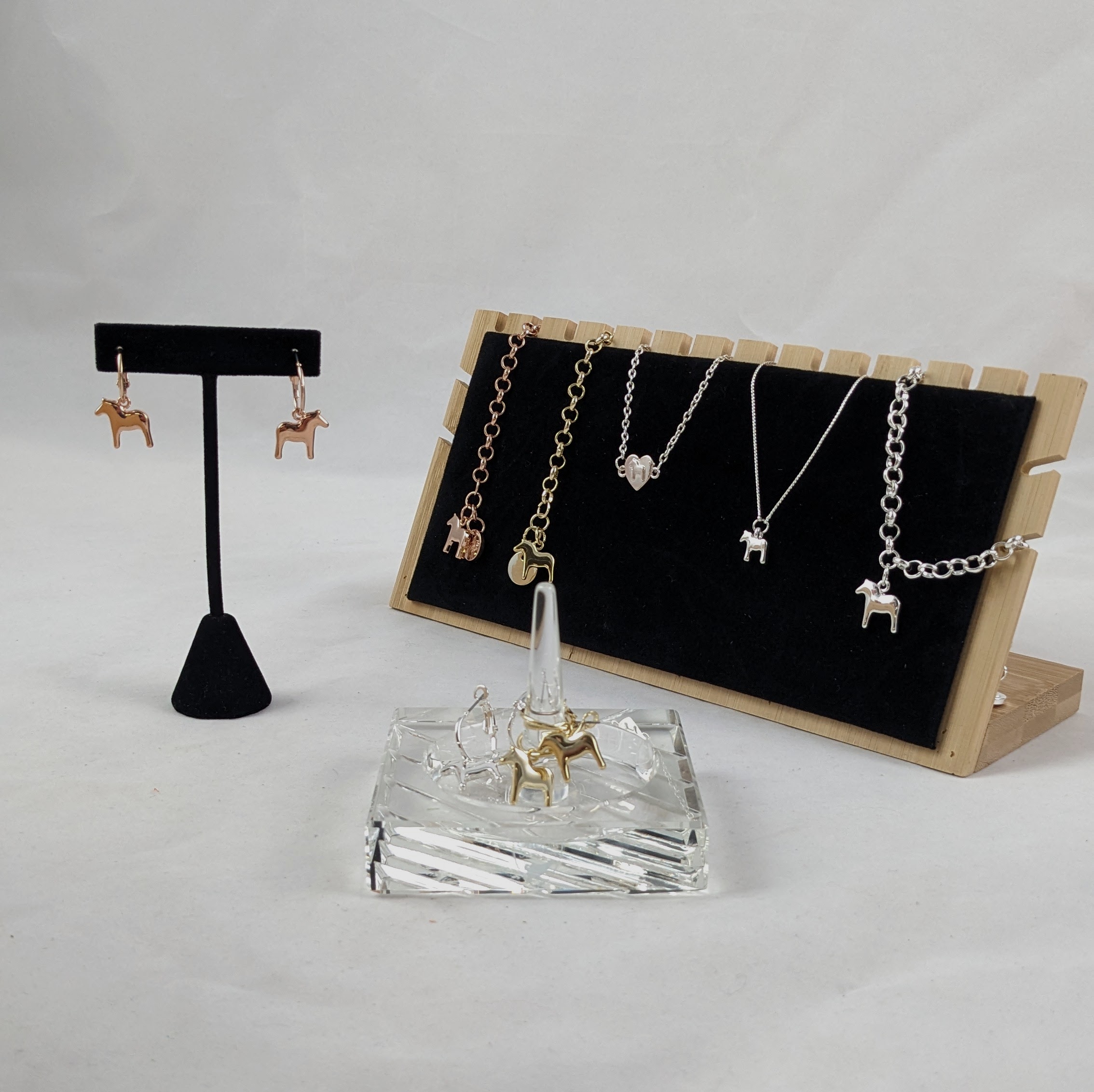A collection of the dala horse bracelets and earrings from Anna Victoria.