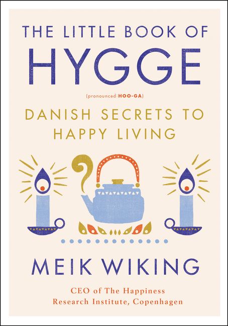 Book cover with title and graphics of a tea kettle and candles.