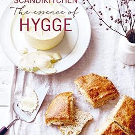 Book cover with title and photo of staged bread and butter on a white tablecloth. 